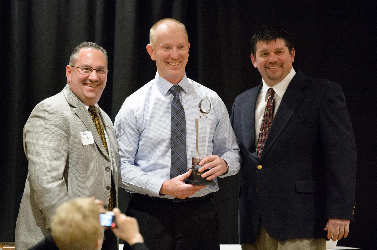 John Koronkiewicz receives the 2014 Russ Young Award from Titan Touchdown Club President John Morelli (L) and UW-Oshkosh head football coach Pat Cerroni (R)