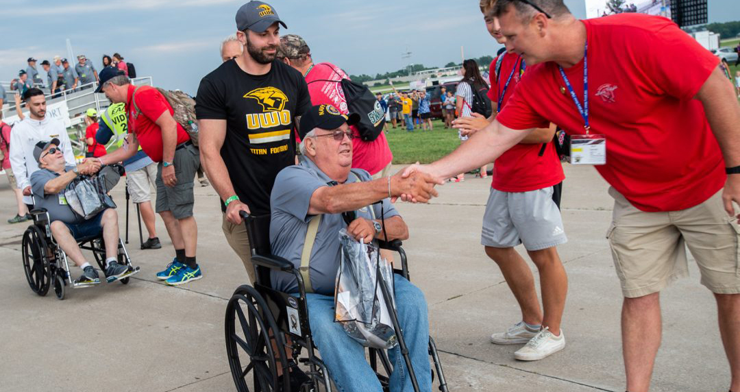 UW-Oshkosh Football Team Assist, Celebrate Honor Flight Veterans