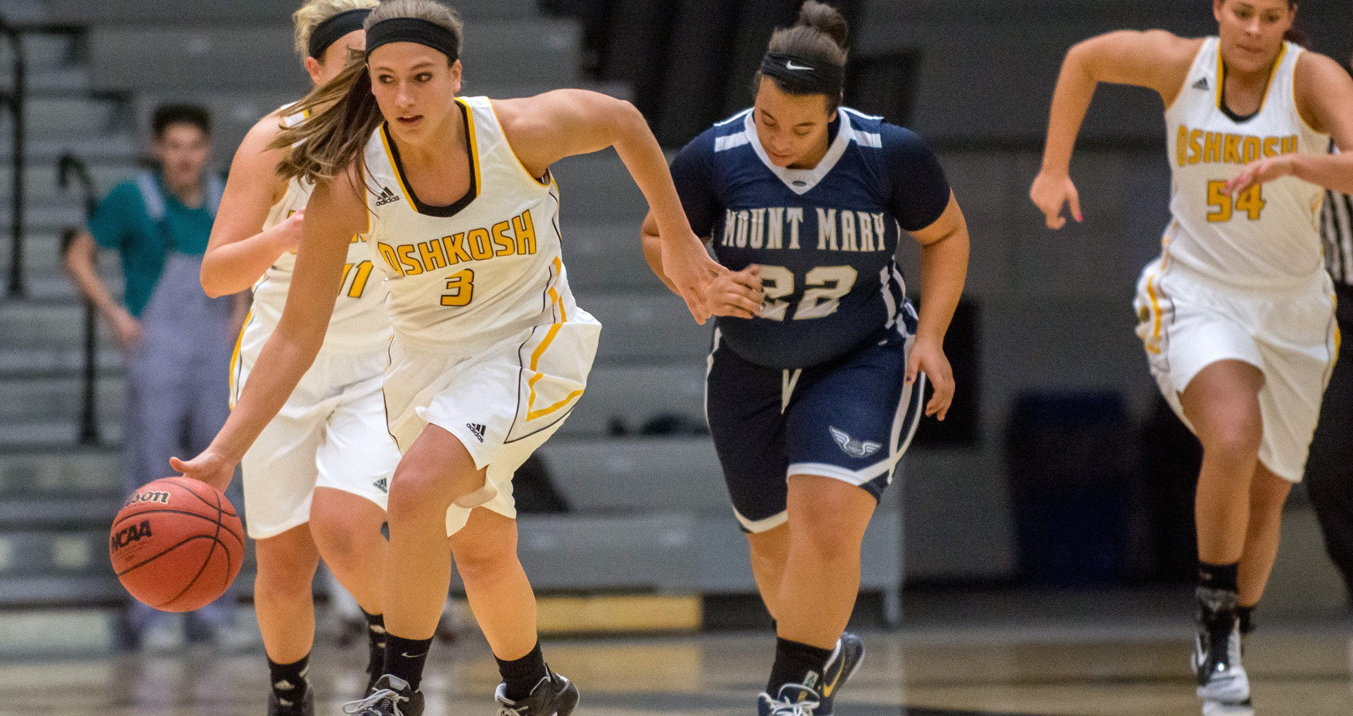 Lauren Peterson, who tallied seven points and three assists, brings the ball up court against the Blue Angels.