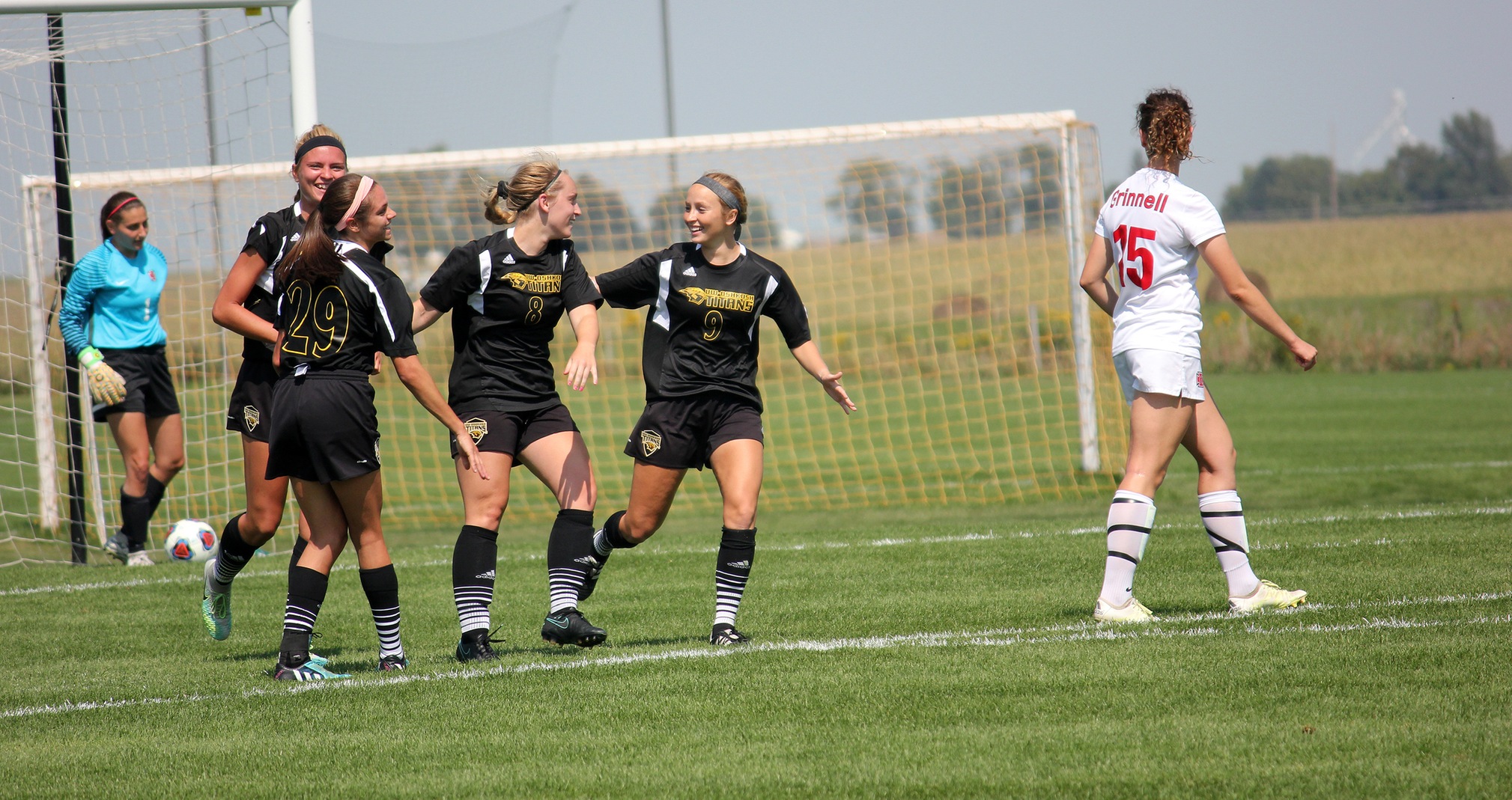 Kendra Jepson (8) is congratulated by her UW-Oshkosh teammates after scoring the match-winning goal.