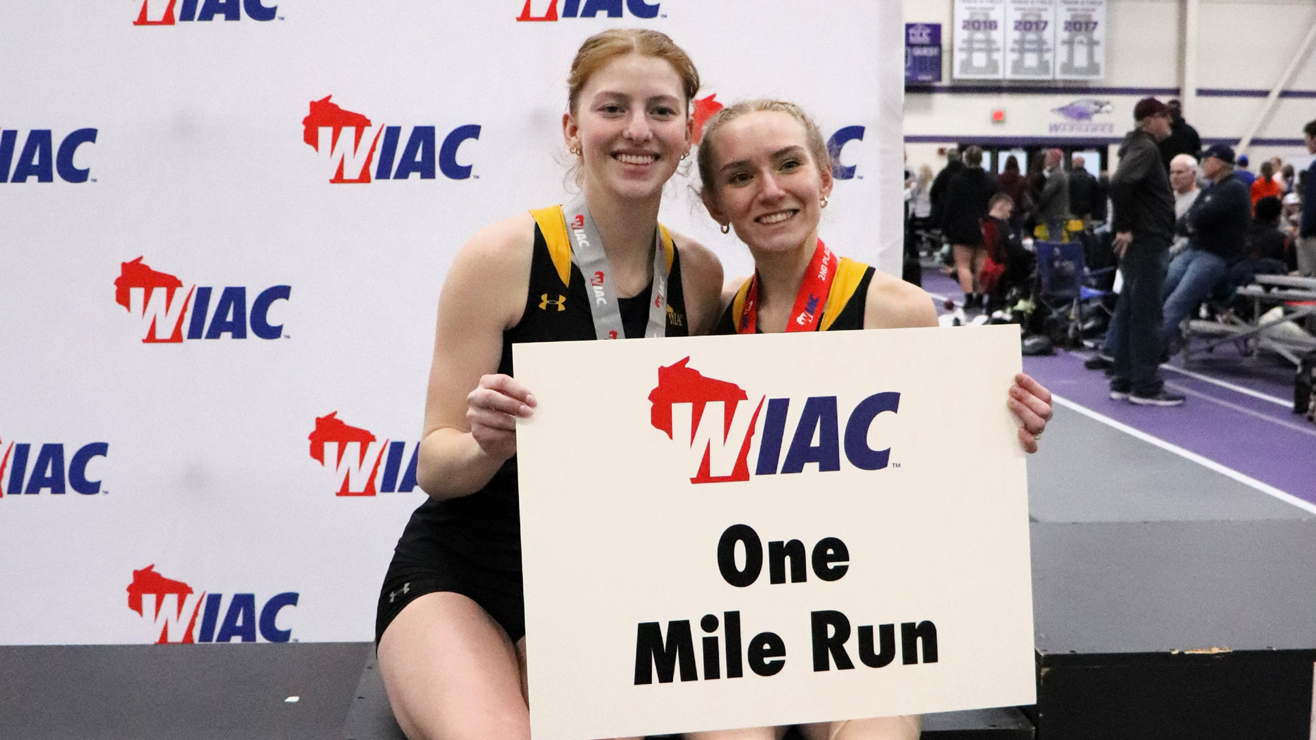 Cyna Madigan (left) and Amelia Lehman (right) after podium finishes in he mile run on Friday. Photo Credit: Autumn Krause, UW-Whitewater Sports Information