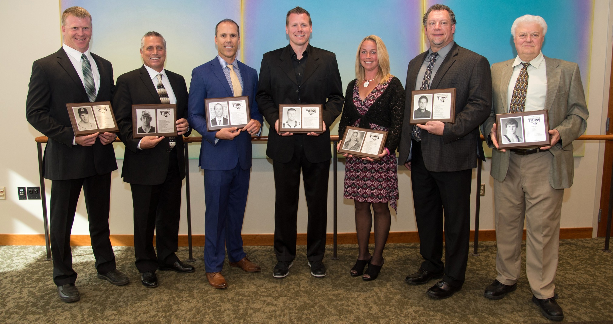 2017 UW-Oshkosh Hall of Fame Inductees (L-R): Craig Lieder, Jeff Carl, Brian Tomalak, Brad Clark, Amy (Wing) Barber, Michael Neumann and Duane Fischer (father LeRoy in photo).