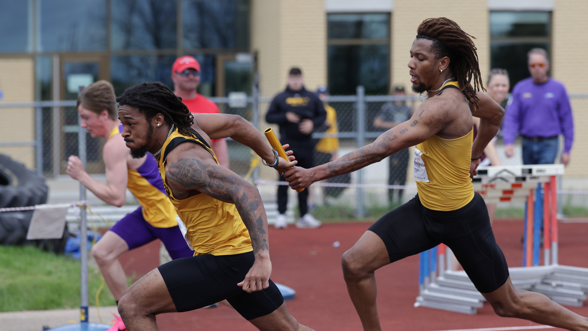 Rashaad Henderson (right) hands the baton off to Londyn Little (left) in the 4x400-meter relay at the 2024 WIAC Championship. Photo Credit: Steve Frommell, UW-Oshkosh Sports Information
