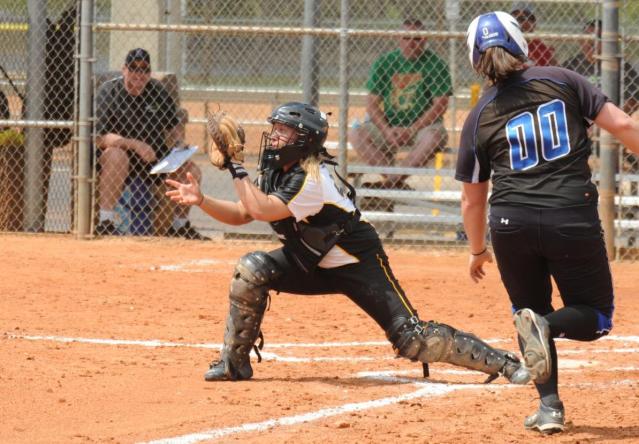 Katie Koepsel tries to get a runner at home plate