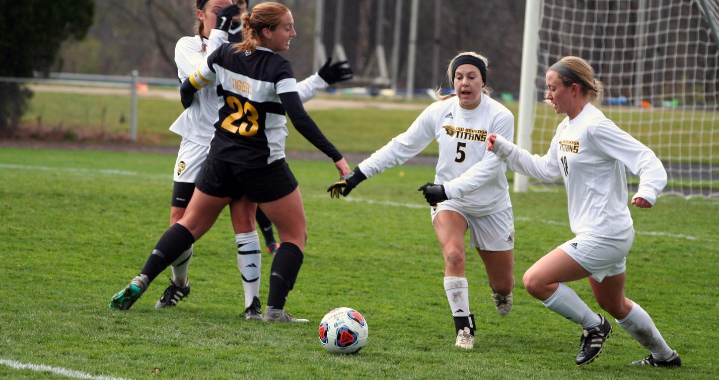 Ashley Siewert (5) and Heidi Hetzel (18) attempt to clear the ball against the Tigers.