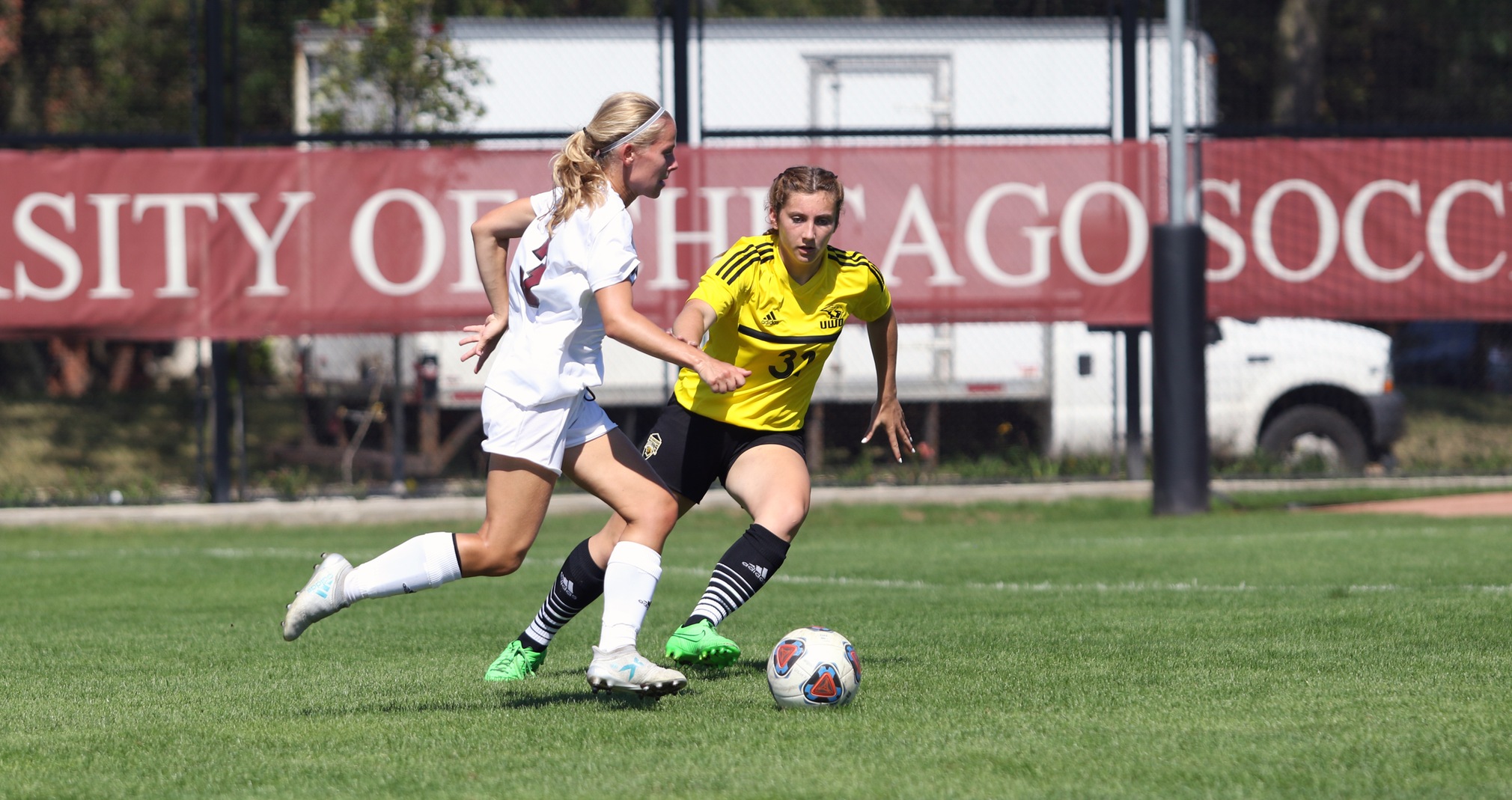 The Titans' Mackenzie Bennett attempts to stop a University of Chicago possession.