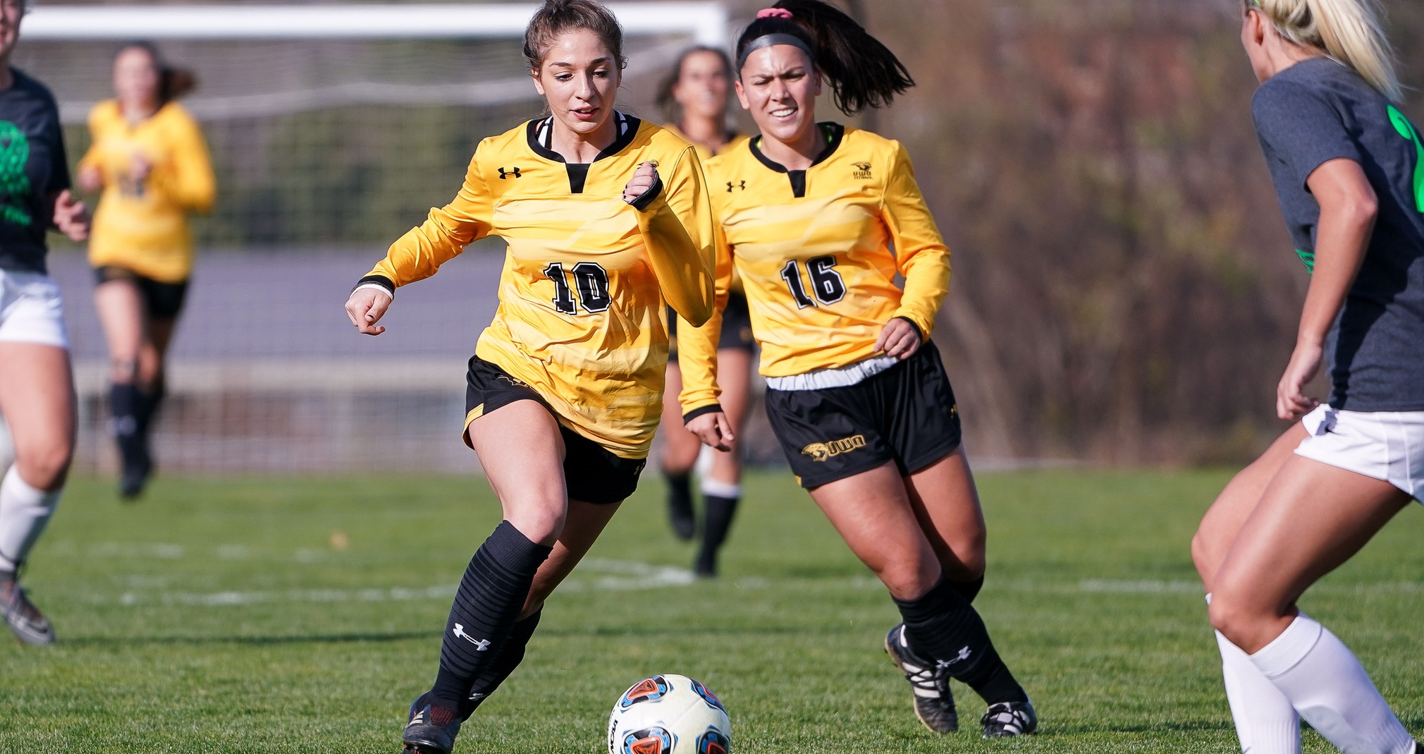 Alexia Poulos plays the ball upfield against the Falcons.